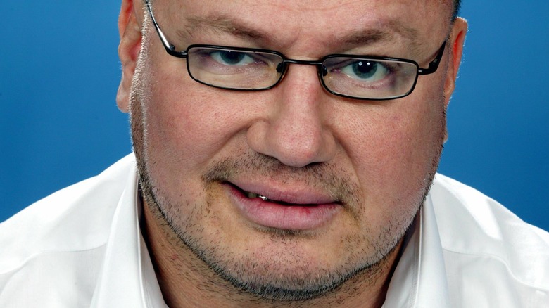 Tony Halme white shirt glasses grinning