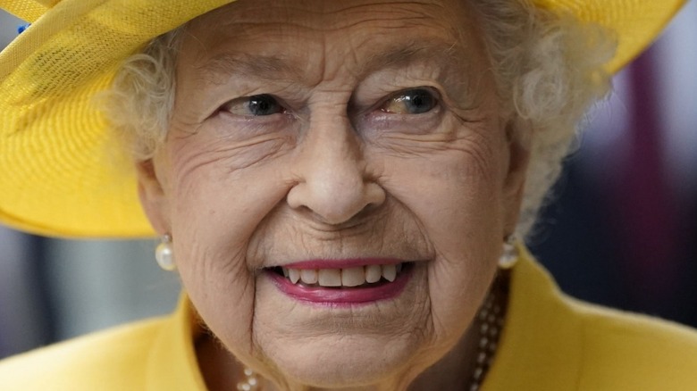Queen Elizabeth smiling in yellow