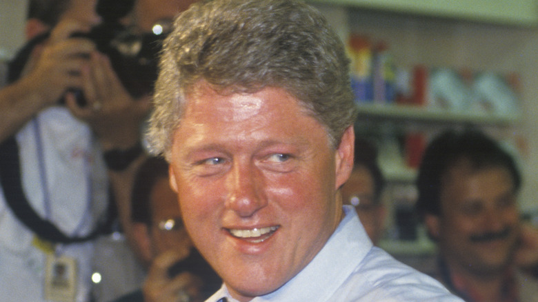 smiling sweaty bill clinton with photographers