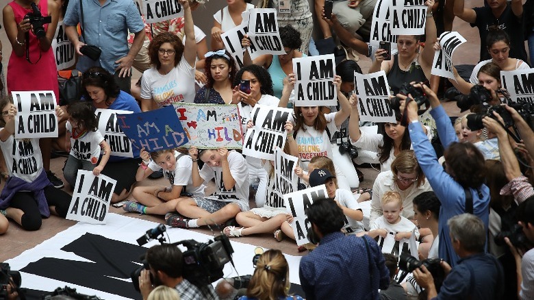 Protestors holding anti-deportation signs