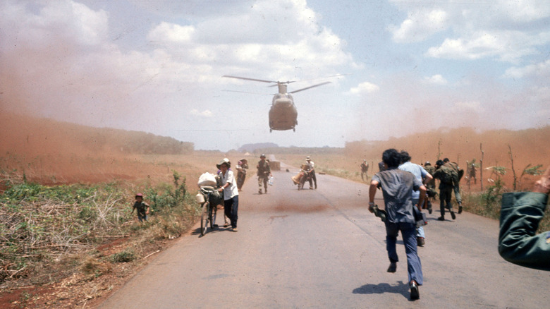 Civilians run from opposing forces in Saigon