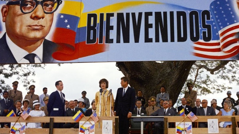 John and Jaqueline Kennedy giving speech