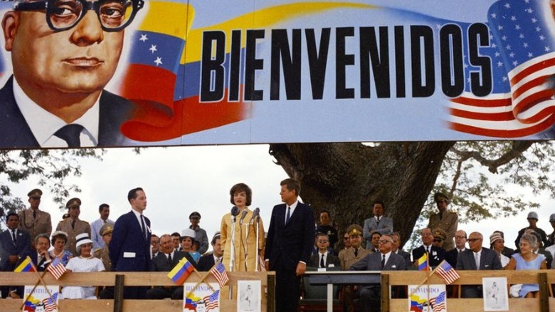 John and Jaqueline Kennedy giving speech