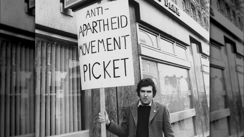 Man holding anti-apartheid sign