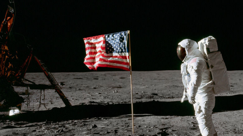 Buzz Aldrin by flag on moon