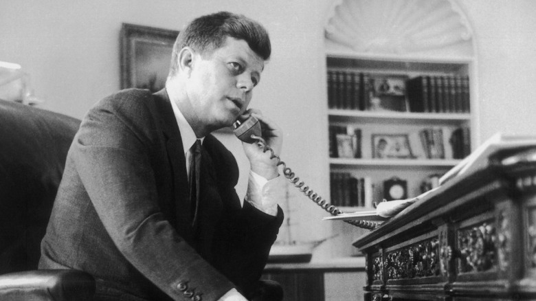 John Kennedy on telephone at desk