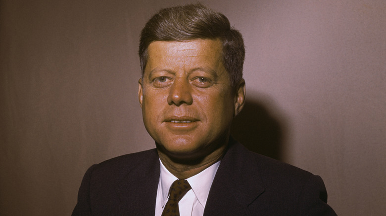 John Kennedy smiling in suit