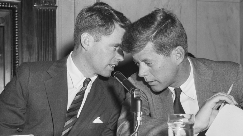 Robert Kennedy whispering to John F. Kennedy