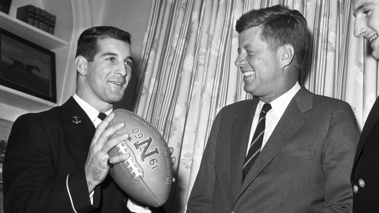 Joe Bellino holds football and jokes with President Kennedy