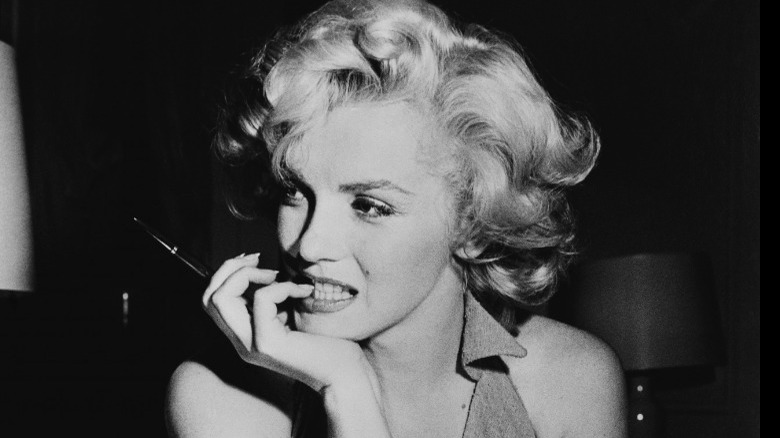 Marilyn Monroe smiling on bench