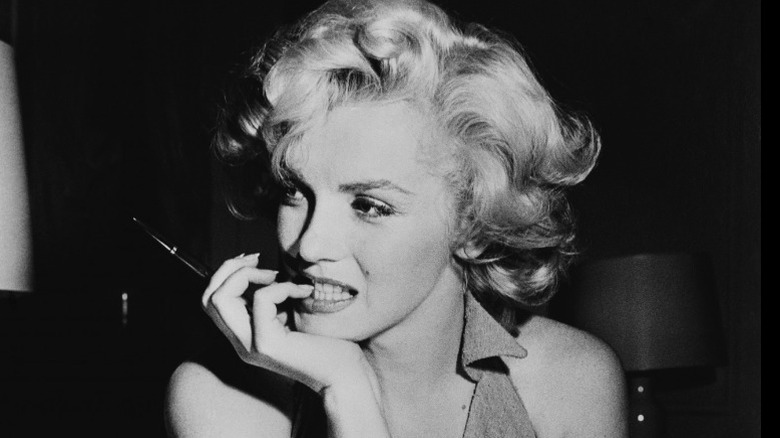 Marilyn Monroe smiling on bench