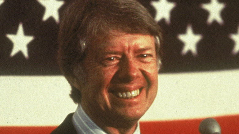 Jimmy Carter posing with flag