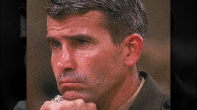Oliver North resting chin on hand