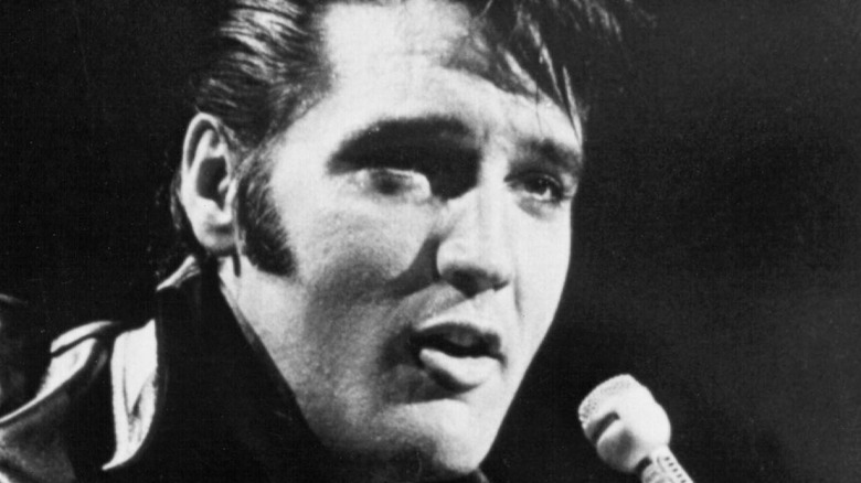 Elvis Presley singing into a microphone