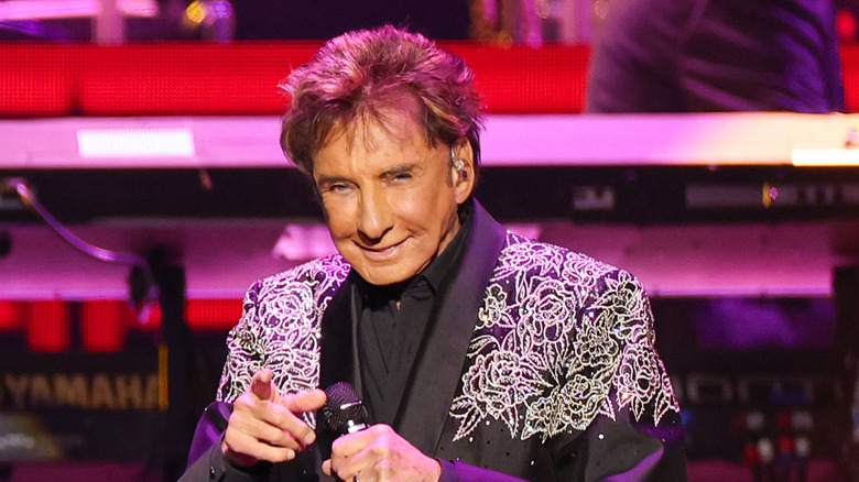 Barry Manilow pointing at audience from stage