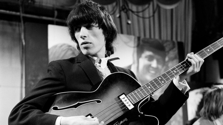 Bill Wyman holding his bass during a Rolling Stones performance