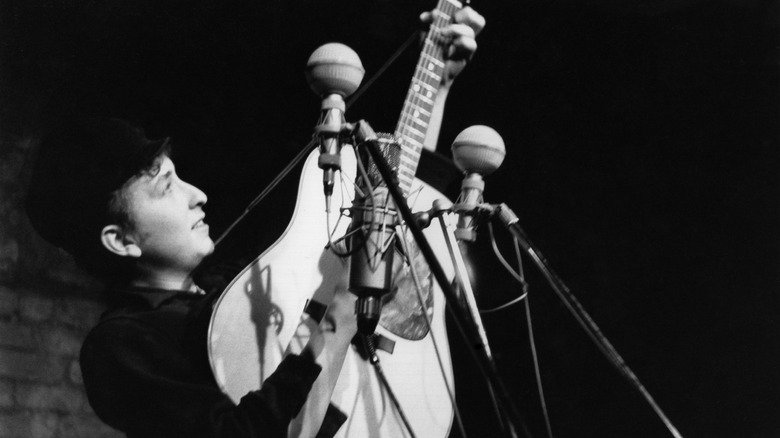 Young Bob Dylan playing guitar
