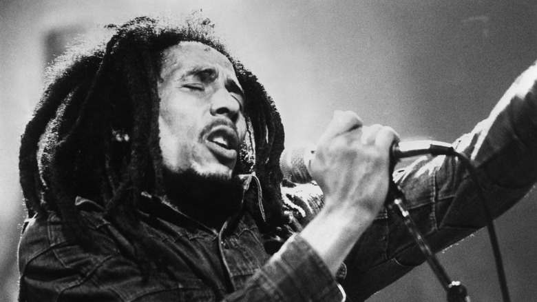 Bob Marley singing into mic on stage