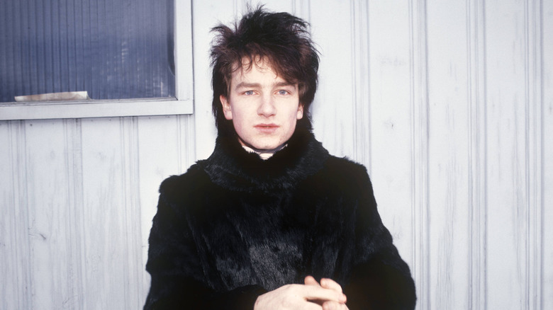 Young Bono standing alone