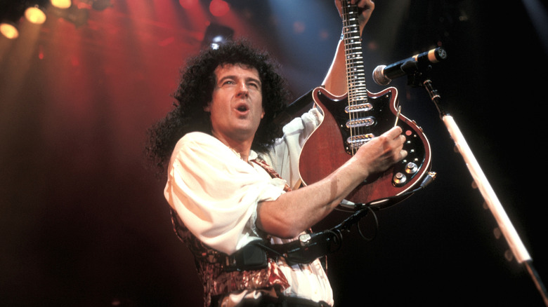 Brian May playing guitar on stage