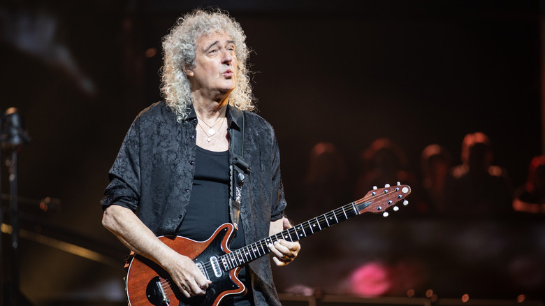 Brian May playing guitar on stage, 2000s