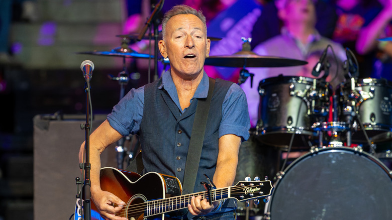 Bruce Springsteen onstage with acoustic guitar