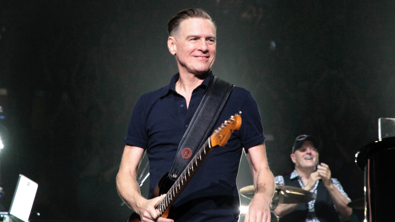 Bryan Adams smiling onstage