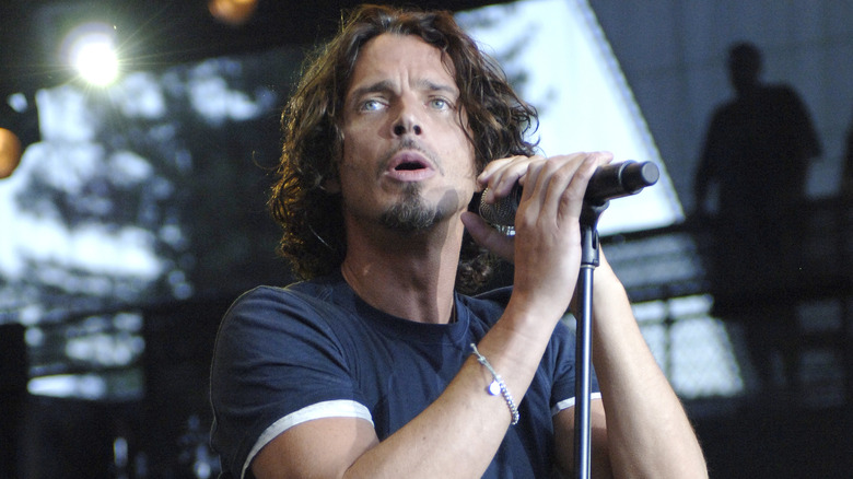 Chris Cornell wearing a blue shirt and singing onstage in 2008