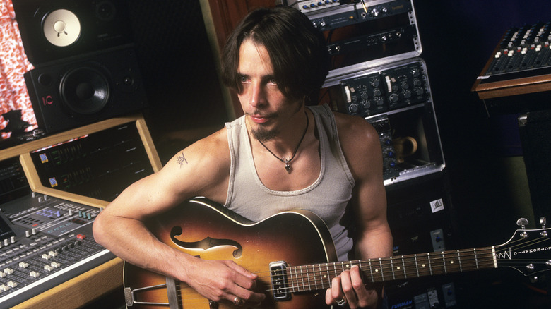 Chris Cornell holding guitar in studio