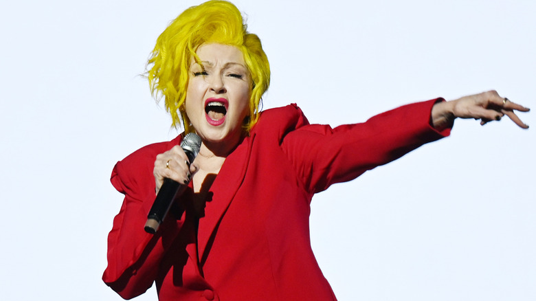 Cyndi Lauper performing in red jacket