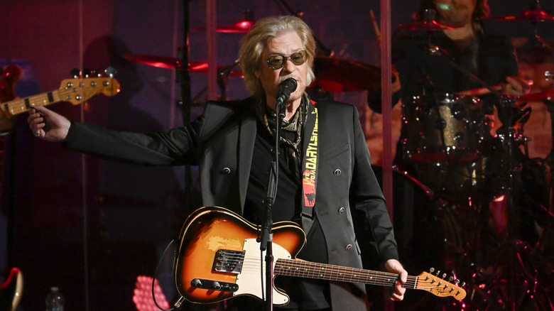 Daryl Hall standing on a stage