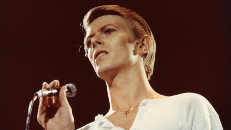 David Bowie holding a microphone.
