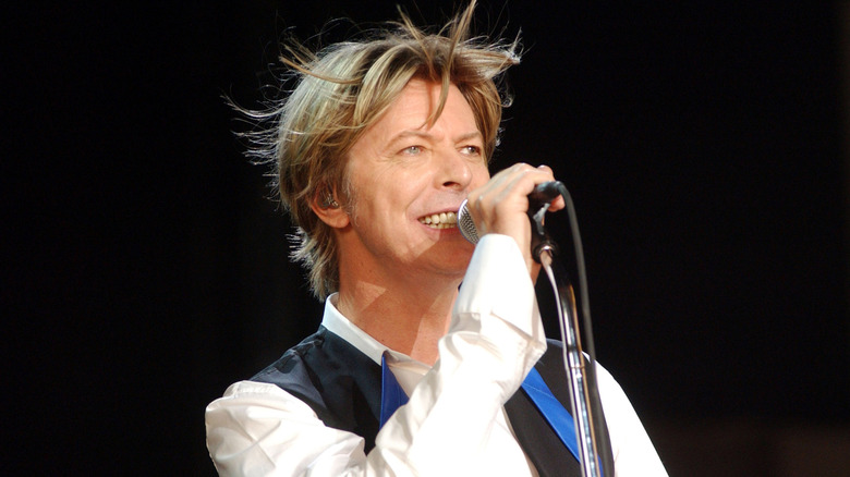 David Bowie holding a microphone