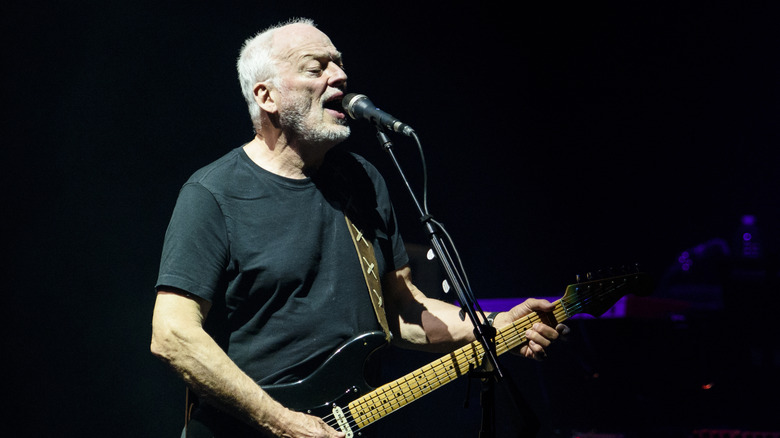 David Gilmour onstage with guitar and microphone