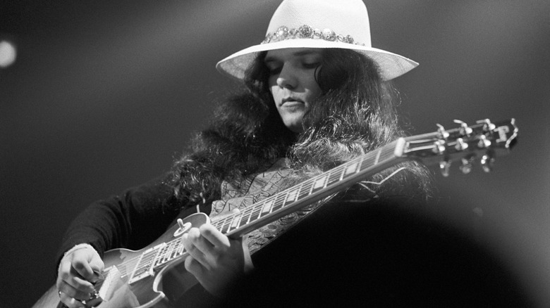 Gary Rossington plays guitar onstage at the Omni Coliseum in 1975