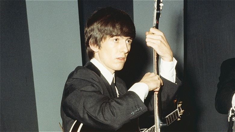 George Harrison holding a guitar