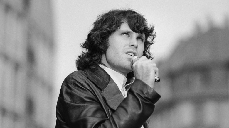 Jim Morrison singing outside in leather jacket