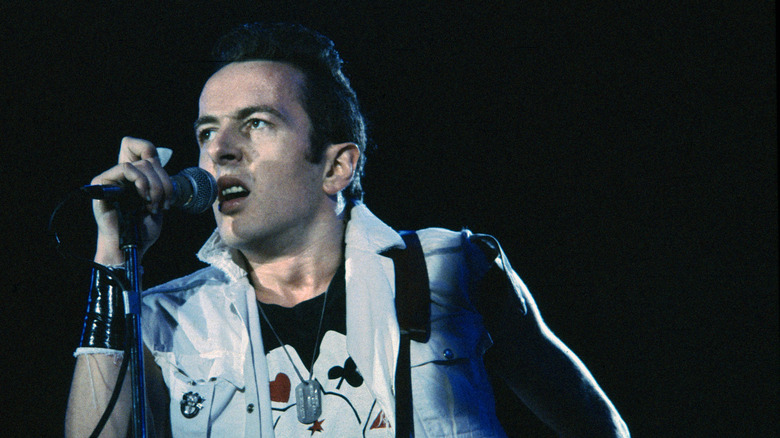 Joe Strummer onstage in denim jacket