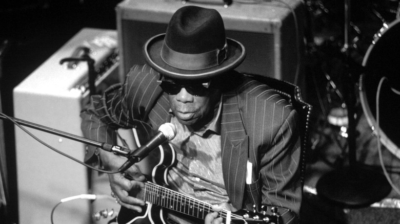 John Lee Hooker with guitar and microphone