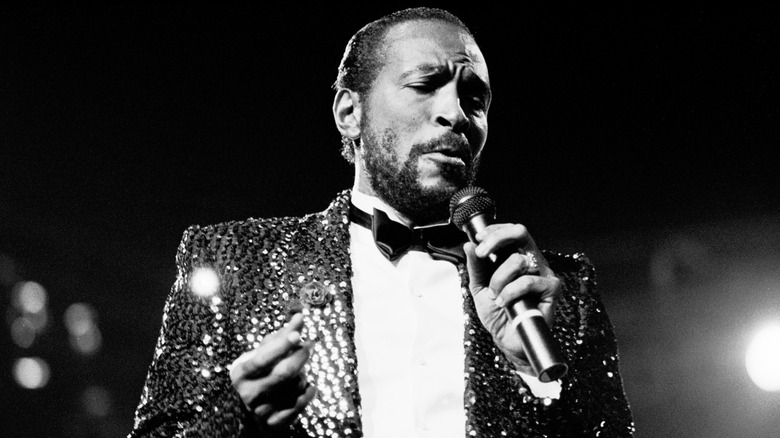 A black and white photo of Marvin Gaye performing.