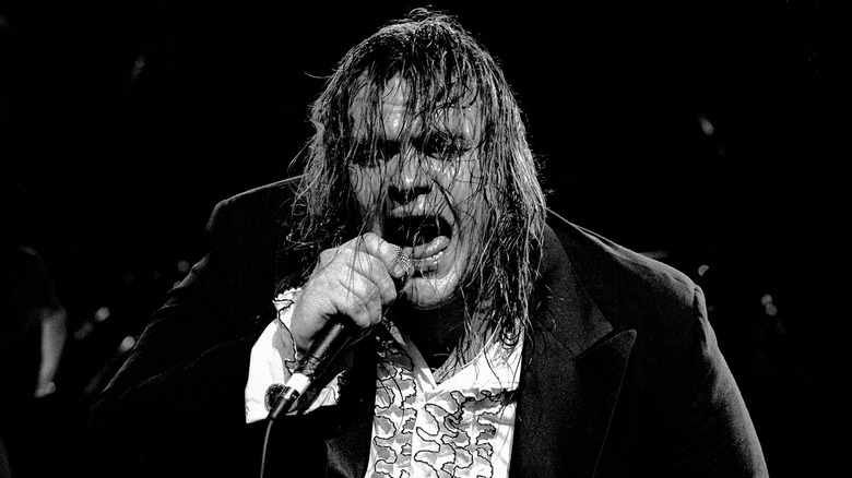 Meat Loaf sweaty and singing into microphone