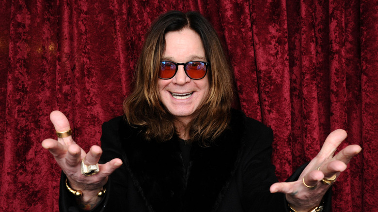 Ozzy Osbourne gesturing and smiling for the camera