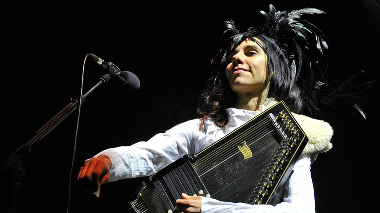 PJ Harvey performing on stage