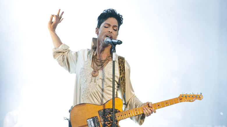 Prince playing guitar and singing