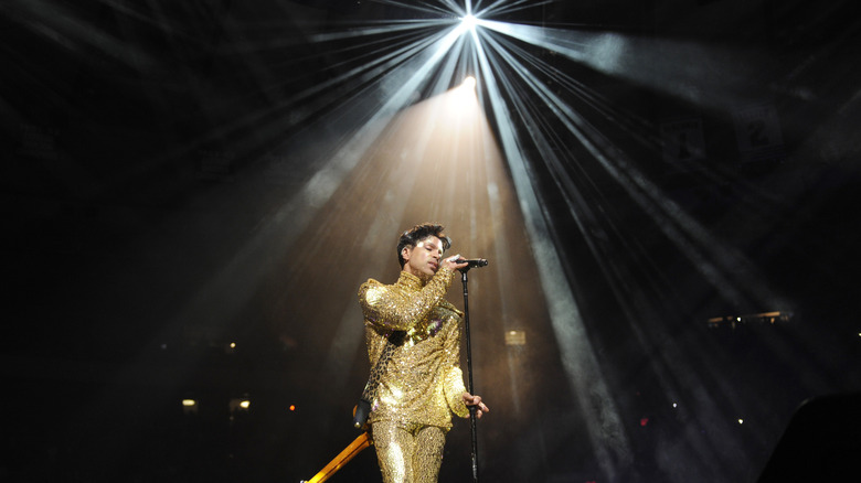 Prince singing under spotlight