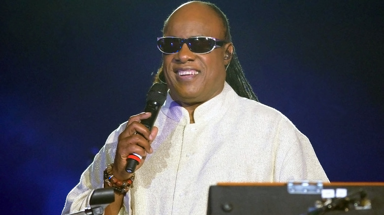 Stevie Wonder holding a microphone.