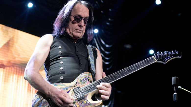 Tedd Rundgren performing on a psychedelic patterned guitar in 2021