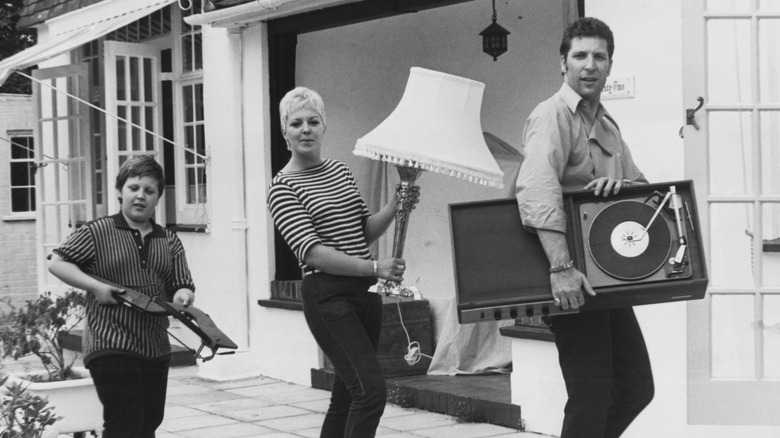 Tom Jones and family carrying furniture