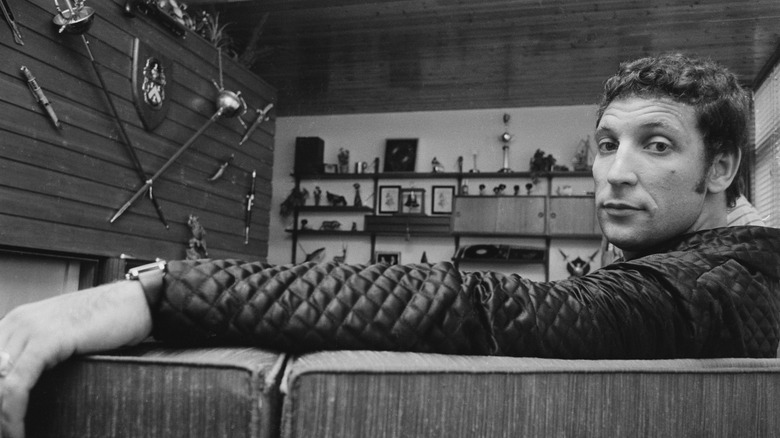 Tom Jones sitting on couch at home