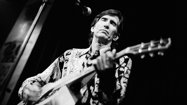 Townes Van Zandt playing guitar on stage